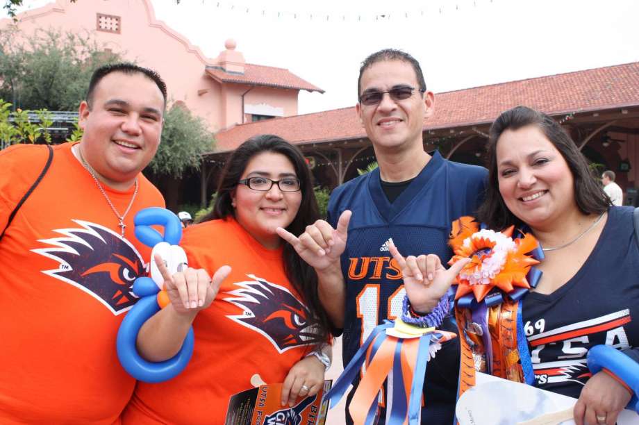 Group of UTSA fans giving birds up at tailgate party